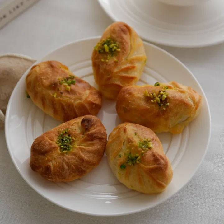 Almond qotab pastries on a plate